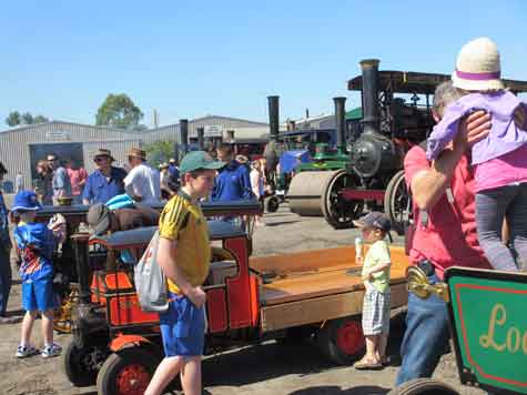 busy scene of visitors inspecting mobile exhibits