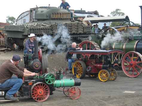 miniature engines with tank in the background